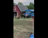 Girl blue school bus red barn 