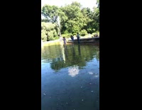 Couple rides a bike at flooded park 