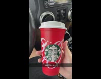 Guy hold Starbucks red cup  car crash