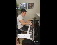 Guy plays piano and solves rubiks cube 