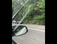 Man records music video in front of car