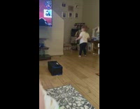 Toddler Girl Bottle Flips Against Wall Perfectly