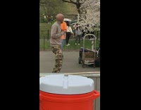 Guy dances with green parrot on shoulder