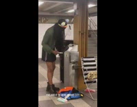 Person blow dries their hair in subway station