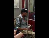 Man button down blue shirt canada black cap on phone lets rat crawl down shirt