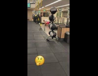 Man gets on all fours on yoga mat and head bangs at the gym