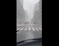 Cars stop on street due to heavy storm