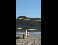 Lady in white poses with surfboard 