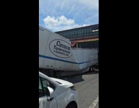 Long white semi truck with crushed container