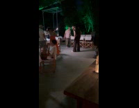 Man with hat poses for two phones