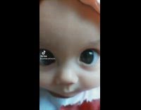 Baby wearing a dress and a headband with large eyes