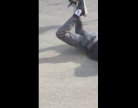 Guy green helmet on skateboard falls down hill