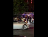 People dance to music on street night