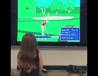 Girl plays golf game on TV