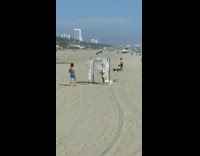 Girl homemade decorative arch white cloth beach 