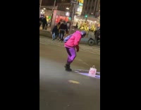 Red jacket girl dances by paper bag 