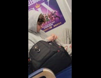 Man gray hoodie cut fingernails in train