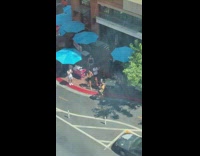 Man yellow sleeveless shirt back flip sidewalk