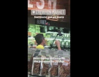 Guy takes selfie with orange at market