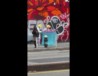Two people in costumes collect things on table then move