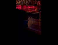 Bartender gives bowl of water to dog