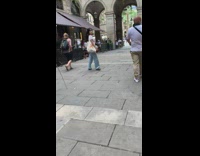 Woman with a bag walks in front of camera on tripod