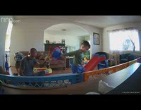 Little boy throws toy shield at his dads face