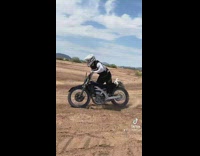 Guy jumps and falls off dirt bike 