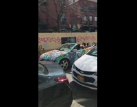 Guy sings in colorful painted convertible car