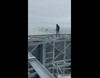 Guy walks around highest point of skyscraper 