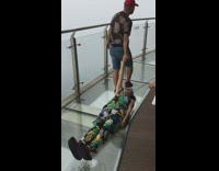 Guy drags lady on back across glass