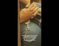Guy chains himself to grey suitcase subway