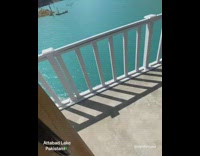 Guy white balcony blue lake water mountain 