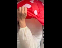 Woman mushroom inflatable costume enter subway turnstile