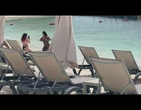 Woman Violet Bikini Kneels at the beach shore Part 1