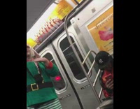 Collab Subway Creatures - Guy in green elf costume with blue hat singing through microphone speaker
