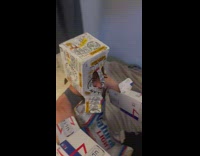 Guy wearing cardboard beer box outfit in bed