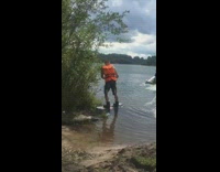 Guy rides wakeboard pulled by raft and plunges into lake water