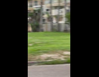 Woman in violet stripes cropped sweater tiktok video at the park