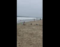 Pink shorts green chair guy beach sand
