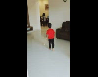 Little boy kicks ball at mom with helmet