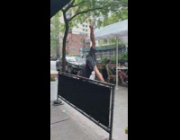 Barefoot guy cartwheels down sidewalk restaurant patio 