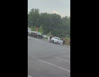 Two men shirtless dance white car parking lot