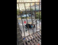 Guy yells at person and blue shirt next to car