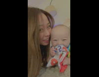 Mom kisses baby and makes him smile 