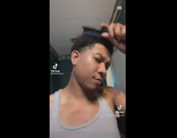 Bald guy pretends to comb hair 