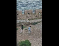 Two women in sweater selfie video while they walk and dance