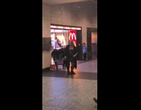 man plays bass woman in dress dances next to him