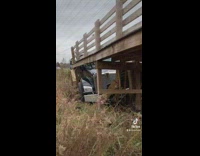 Big tanker truck stuck inside wooden collapsed bridge
