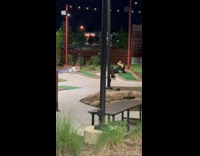 Collab IITW - Woman in black dress lie down to pose at the mini golf course